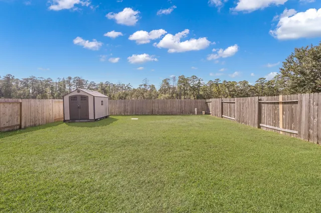 a view of a garden with a house in the background