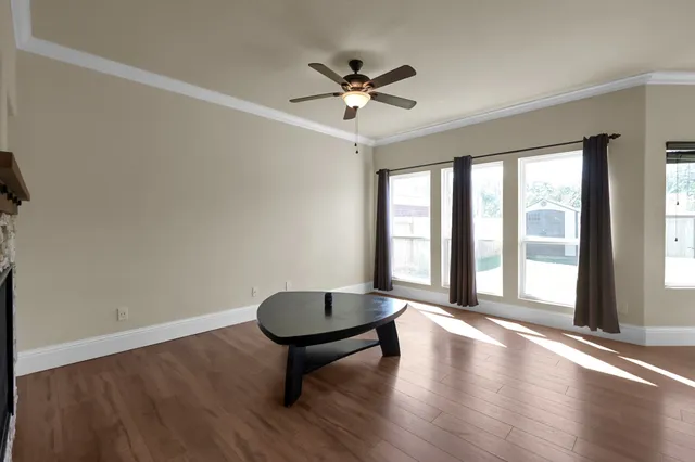 wooden floor in an empty room with a window