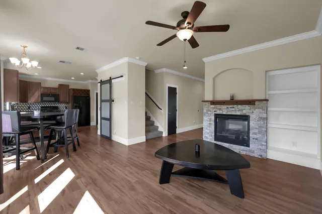 a living room with furniture fireplace and wooden floor