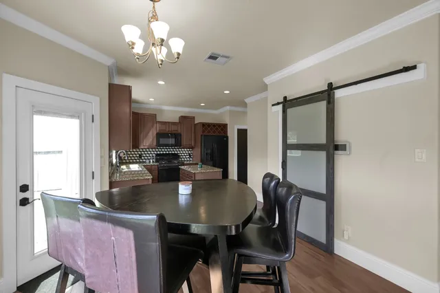 a view of a dining room with furniture and wooden floor