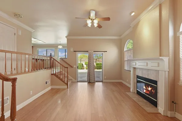 an empty room with a window and a fan