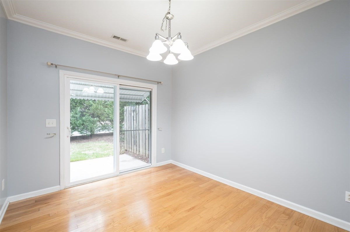 8311 Clasara Circle Raleigh, NC 27613 - Photo 11 of 27 Wonderful breakfast area by the kitchen with hardwood floors, and sliding doors out to a private patio Breakfast Area