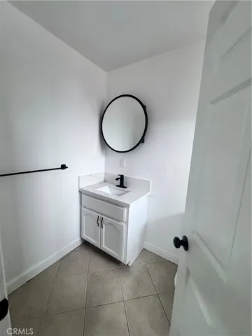 a bathroom with a sink vanity and mirror