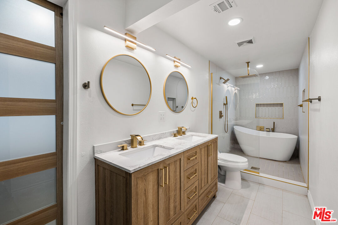 2313 Rynerson Court Simi Valley, CA 93065 - Photo 26 of 45 a bathroom with a double vanity sink mirror and bathtub