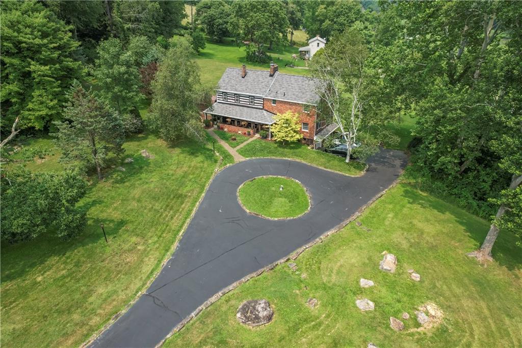 a aerial view of a house with a yard and lake view
