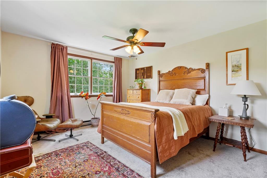 299 Forbes Trail Road Greensburg, PA 15601 - Photo 33 of 42 a bedroom with a bed and a chandelier