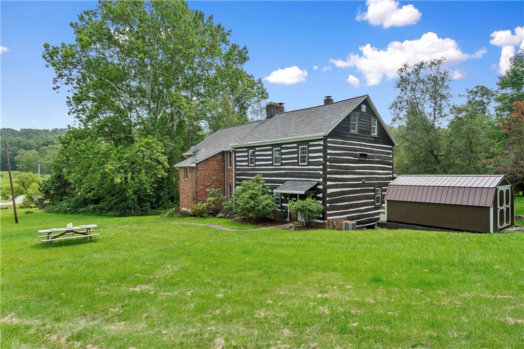 299 Forbes Trail Road Greensburg, PA 15601 - Photo 37 of 42 a view of a house with a yard and a garden