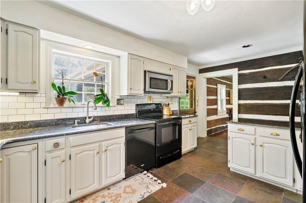 299 Forbes Trail Road Greensburg, PA 15601 - Photo 7 of 42 a kitchen with cabinets appliances and a window