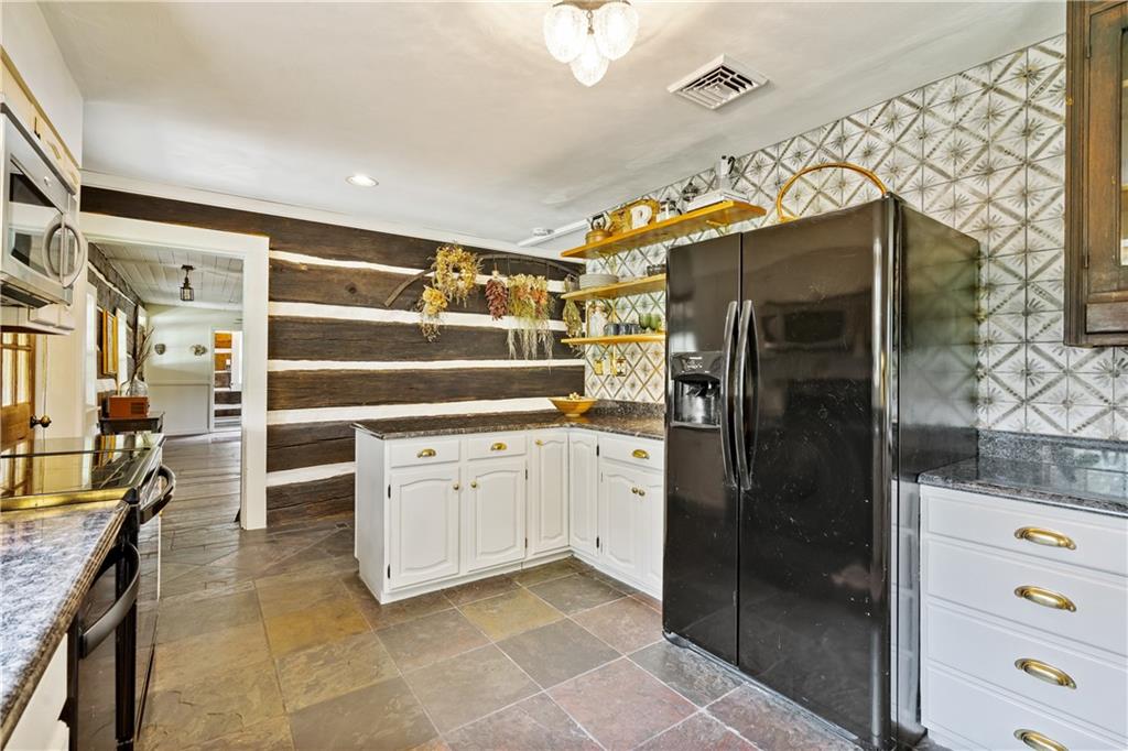 299 Forbes Trail Road Greensburg, PA 15601 - Photo 8 of 42 a kitchen with a refrigerator and cabinets