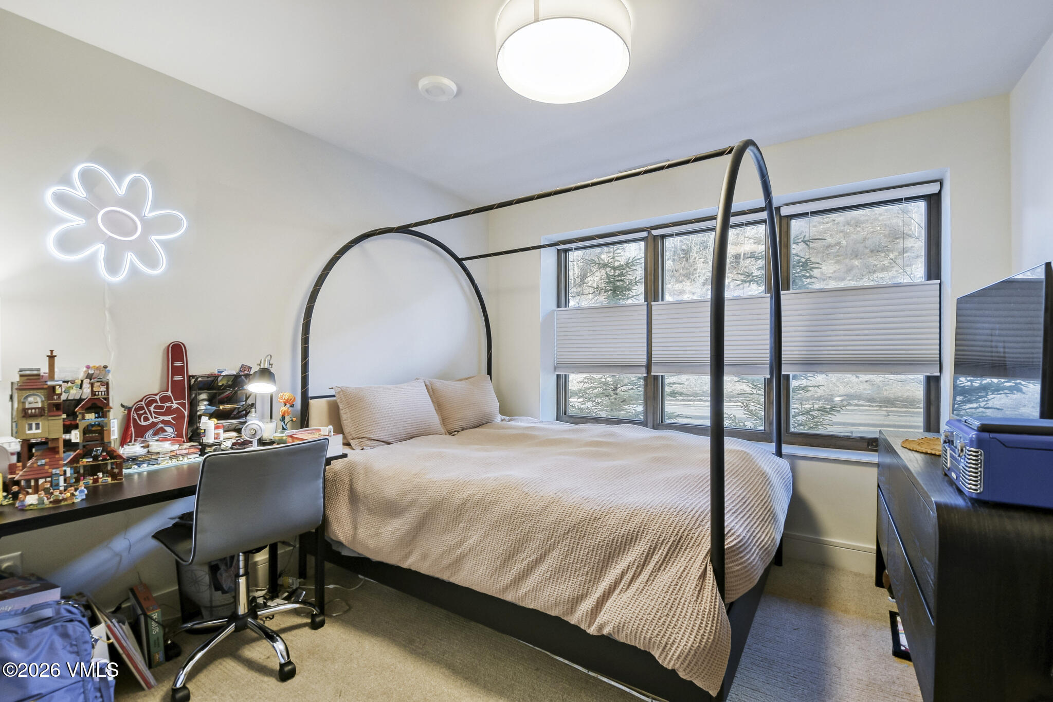 430 South Frontage Road East, Unit RUD Vail, CO 81657 - Photo 12 of 30 a bedroom with a bed and a chandelier
