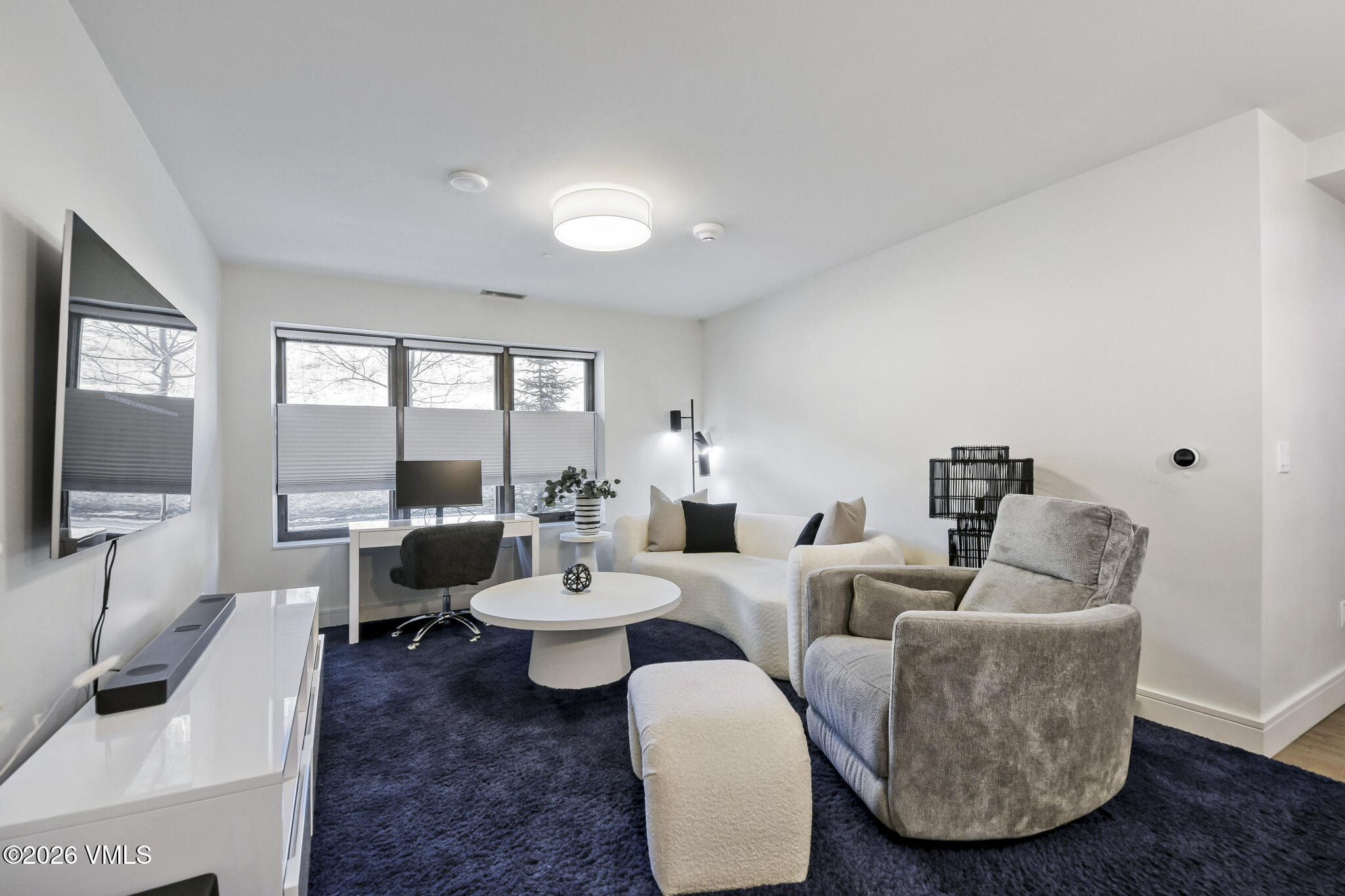 430 South Frontage Road East, Unit RUD Vail, CO 81657 - Photo 3 of 30 a living room with furniture and a flat screen tv