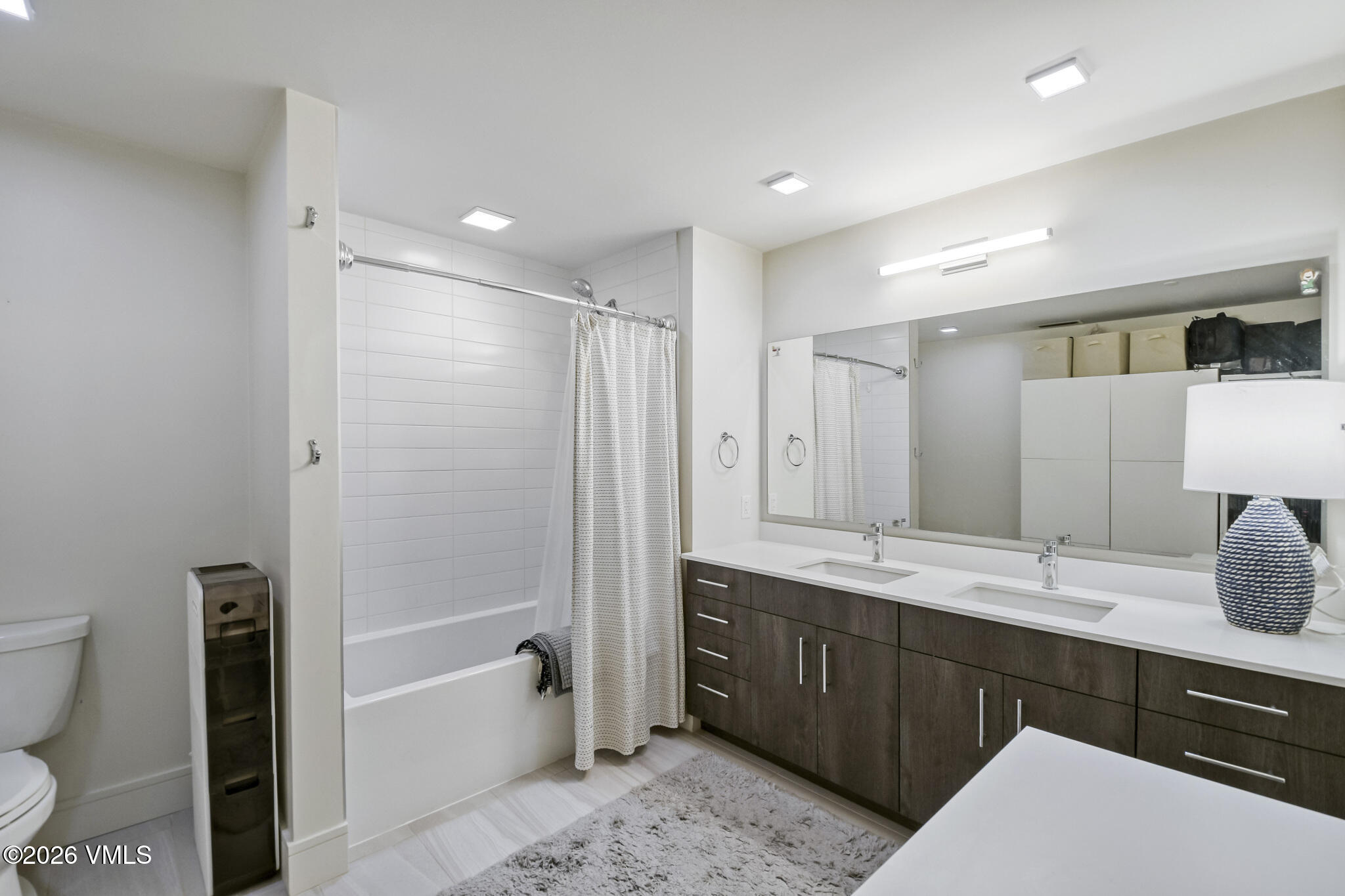 430 South Frontage Road East, Unit RUD Vail, CO 81657 - Photo 10 of 30 a bathroom with a granite countertop sink mirror and bathtub