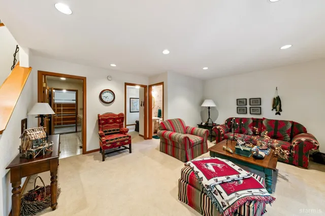 a bedroom with furniture and a large window