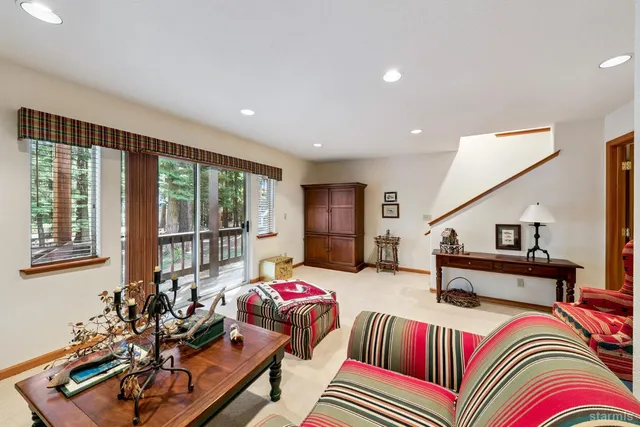 a living room with furniture a chandelier and a window