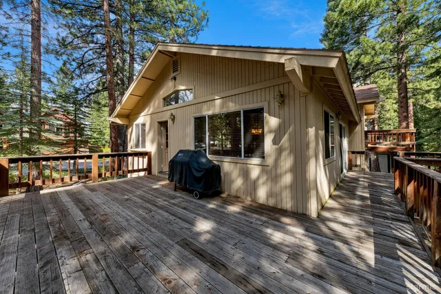 a view of balcony with wooden floor and fence