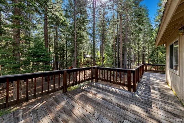 a view of balcony with wooden floor and fence