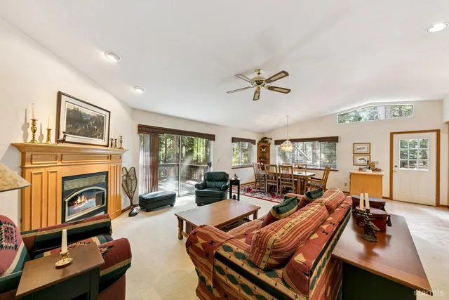 a living room with furniture fireplace and a large window