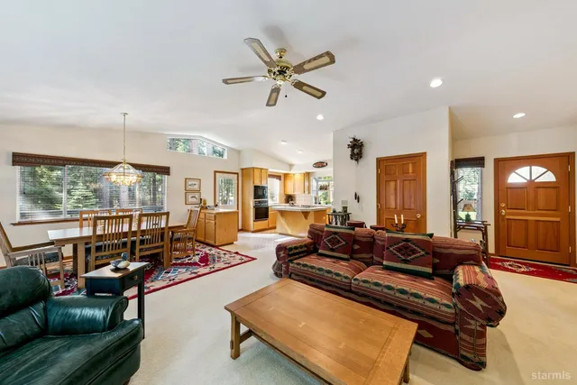 a living room with furniture gym equipment and a large window