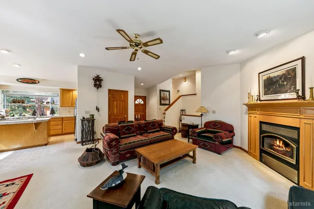 a living room with furniture gym equipment and a fireplace