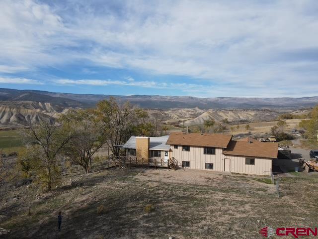 an aerial view of residential houses with city view