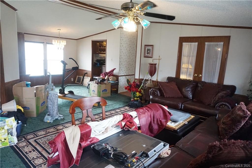 155 Leaning Tree Road Lugoff, SC 29078 - Photo 22 of 28 a living room with furniture and a chandelier