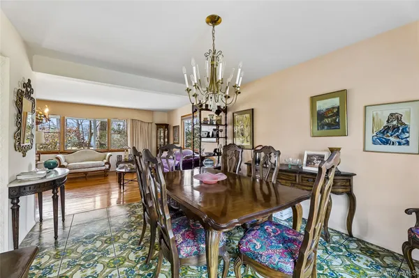 a view of a dining room with furniture and chandelier