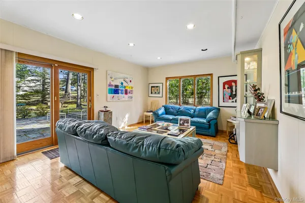 a living room with furniture and large windows