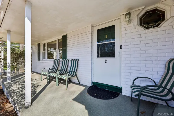 a view of a balcony with chair and front door