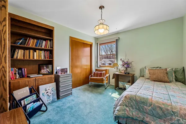 a bedroom with a bed and a book shelf