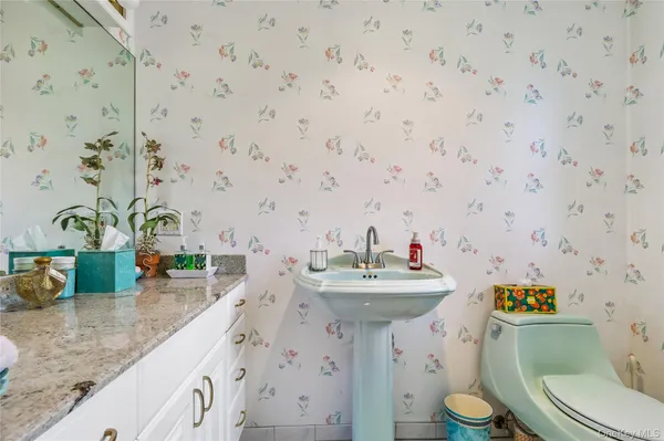 a bathroom with a sink a toilet and mirror