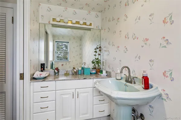 a bathroom with a sink and a mirror