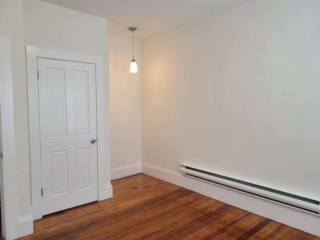 27 Buttonwood Street, Unit 3 Boston, MA 02125 - Photo 13 of 22 a view of empty room with wooden floor