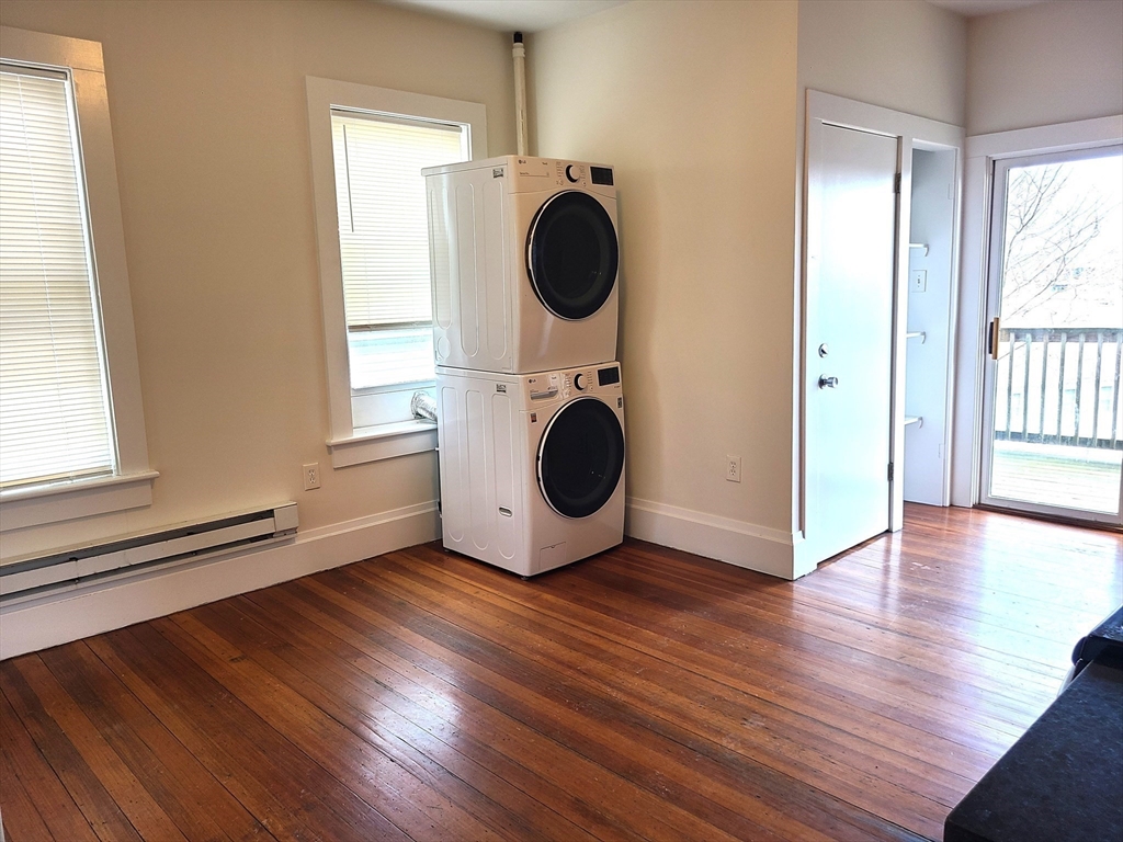 27 Buttonwood Street, Unit 3 Boston, MA 02125 - Photo 19 of 22 a view of a room with wooden floor and windows