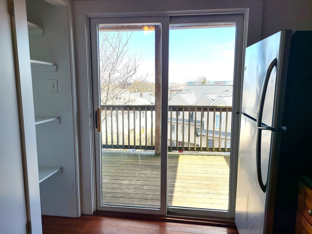 27 Buttonwood Street, Unit 3 Boston, MA 02125 - Photo 20 of 22 a view of a room with a large window and wooden floor