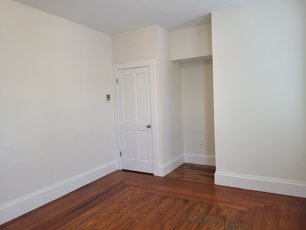 27 Buttonwood Street, Unit 3 Boston, MA 02125 - Photo 4 of 22 a view of an empty room with wooden floor
