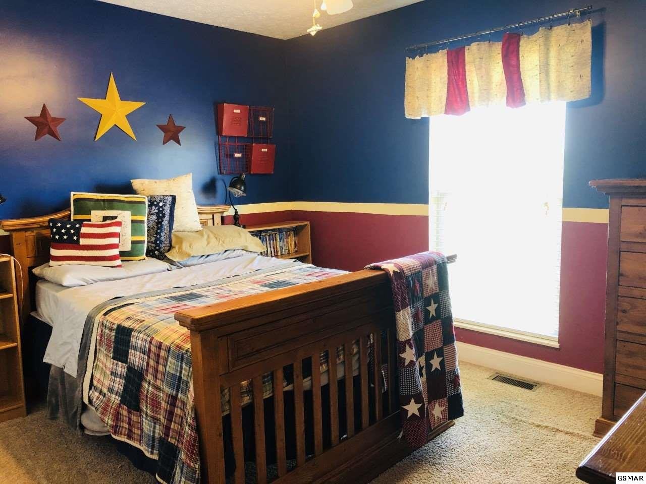 612 Chestnut Grove Road Dandridge, TN 37725 - Photo 12 of 16 a bedroom with a bed a window and dresser