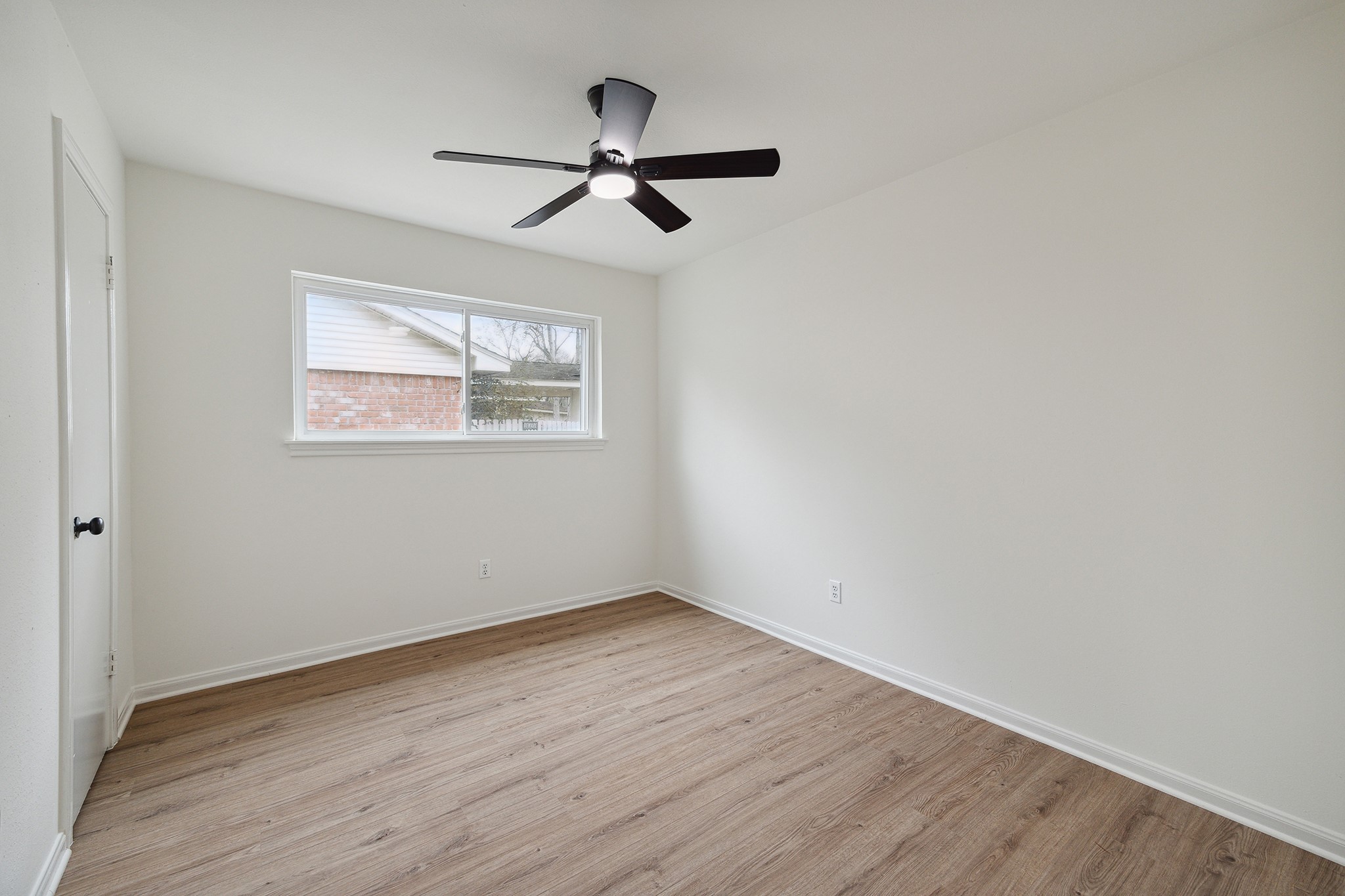 9719 Springmont Drive Houston, TX 77080 - Photo 26 of 32 The image shows the other cozier secondary room! Recent paint, windows, floors, fan/light fixtures! No stone left unturned in the recent renovation!! Good size closet here too!