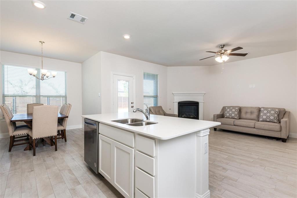 3205 Platinum Road Aubrey, TX 76227 - Photo 13 of 25 a living room with furniture and a fireplace