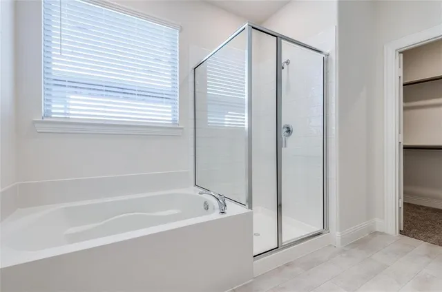 a spacious bathroom with a bathtub and a shower
