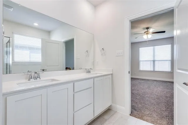 a bathroom with a double vanity sink and a mirror