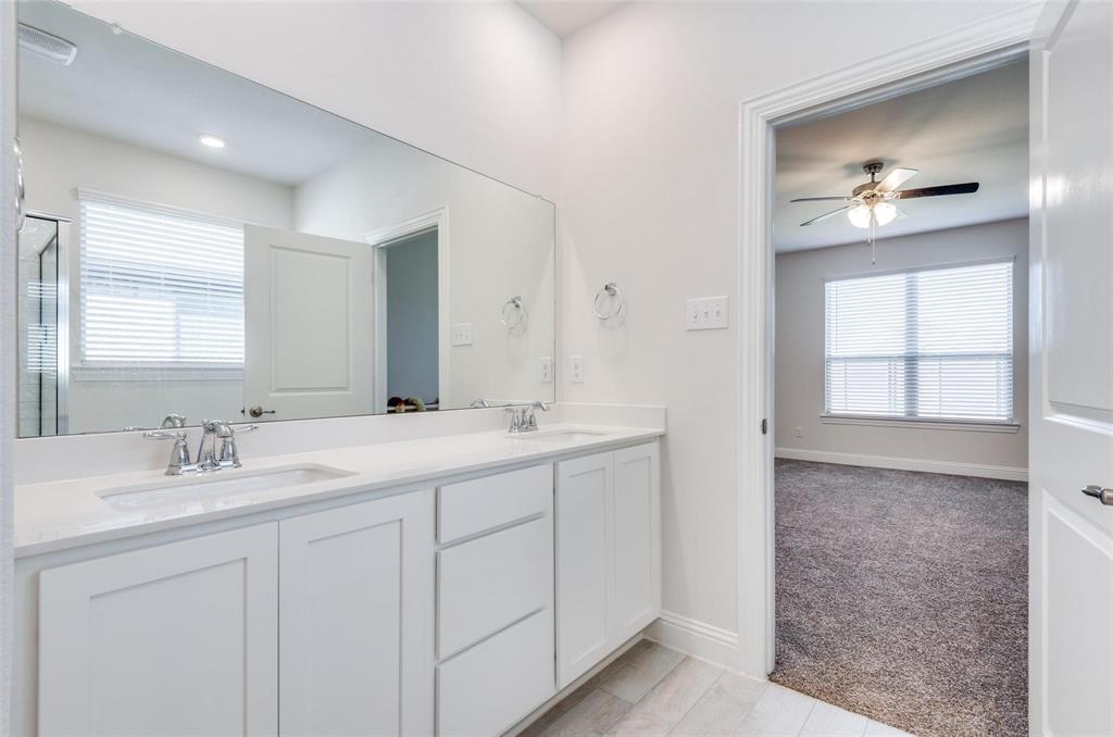 3205 Platinum Road Aubrey, TX 76227 - Photo 20 of 25 a bathroom with a double vanity sink and a mirror