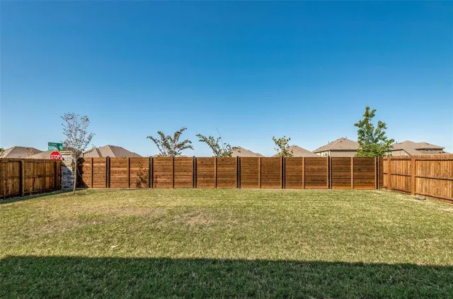 a view of a house next to a big yard