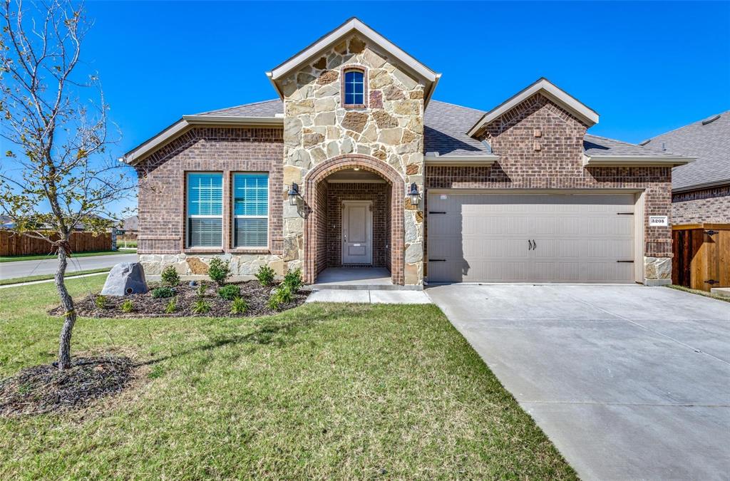 3205 Platinum Road Aubrey, TX 76227 - Photo 3 of 25 a front view of a house with a yard and garage