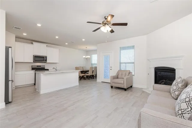 a living room with furniture and kitchen view