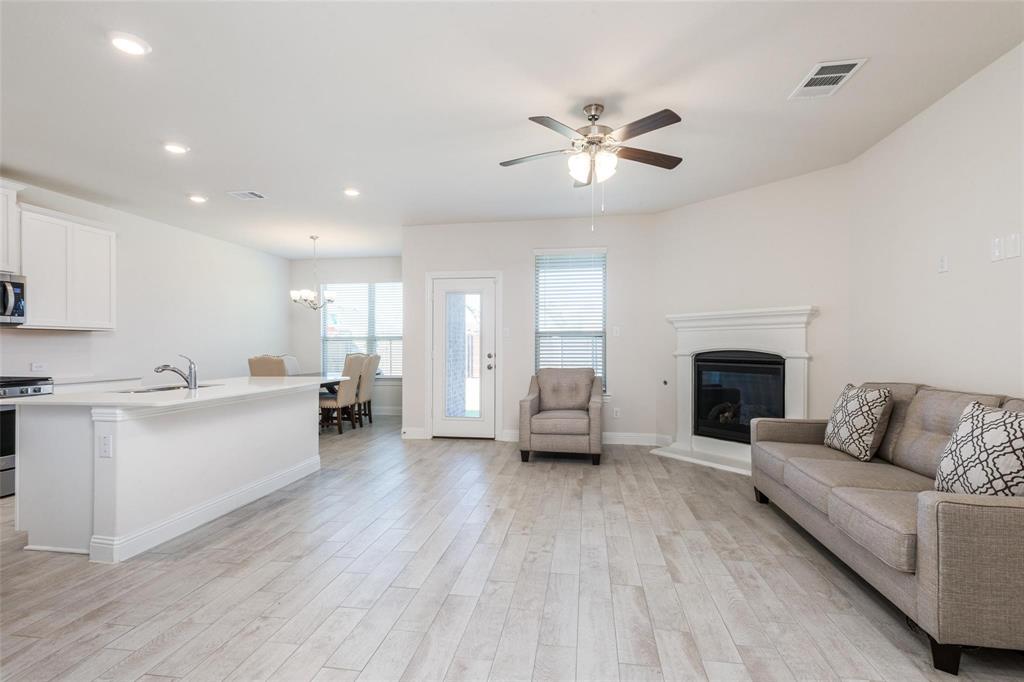 3205 Platinum Road Aubrey, TX 76227 - Photo 8 of 25 a living room with furniture and a fireplace