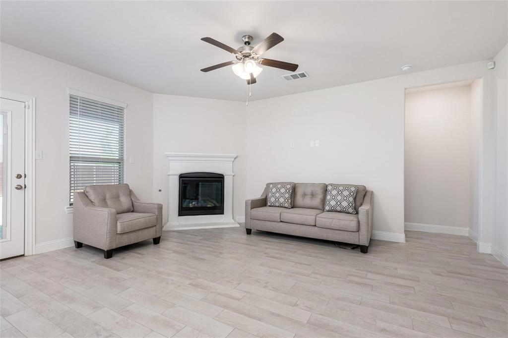 3205 Platinum Road Aubrey, TX 76227 - Photo 9 of 25 a living room with furniture and a fireplace