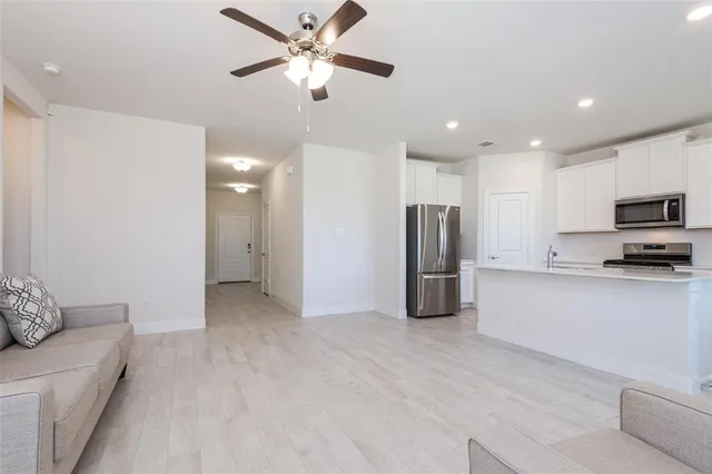 a view of a kitchen with a sink and stainless steel appliances