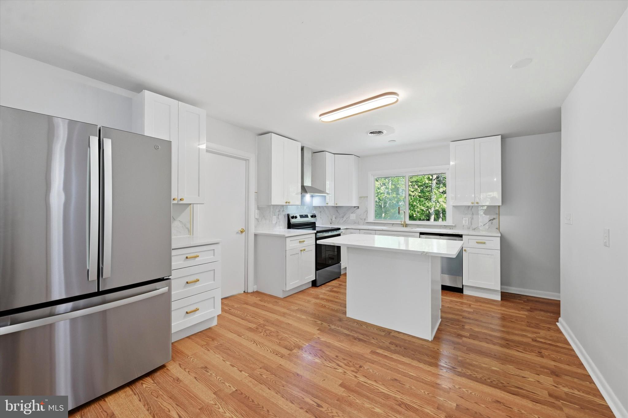 103 Baynard Boulevard Wilmington, DE 19803 - Photo 11 of 35 a kitchen with white cabinets and stainless steel appliances