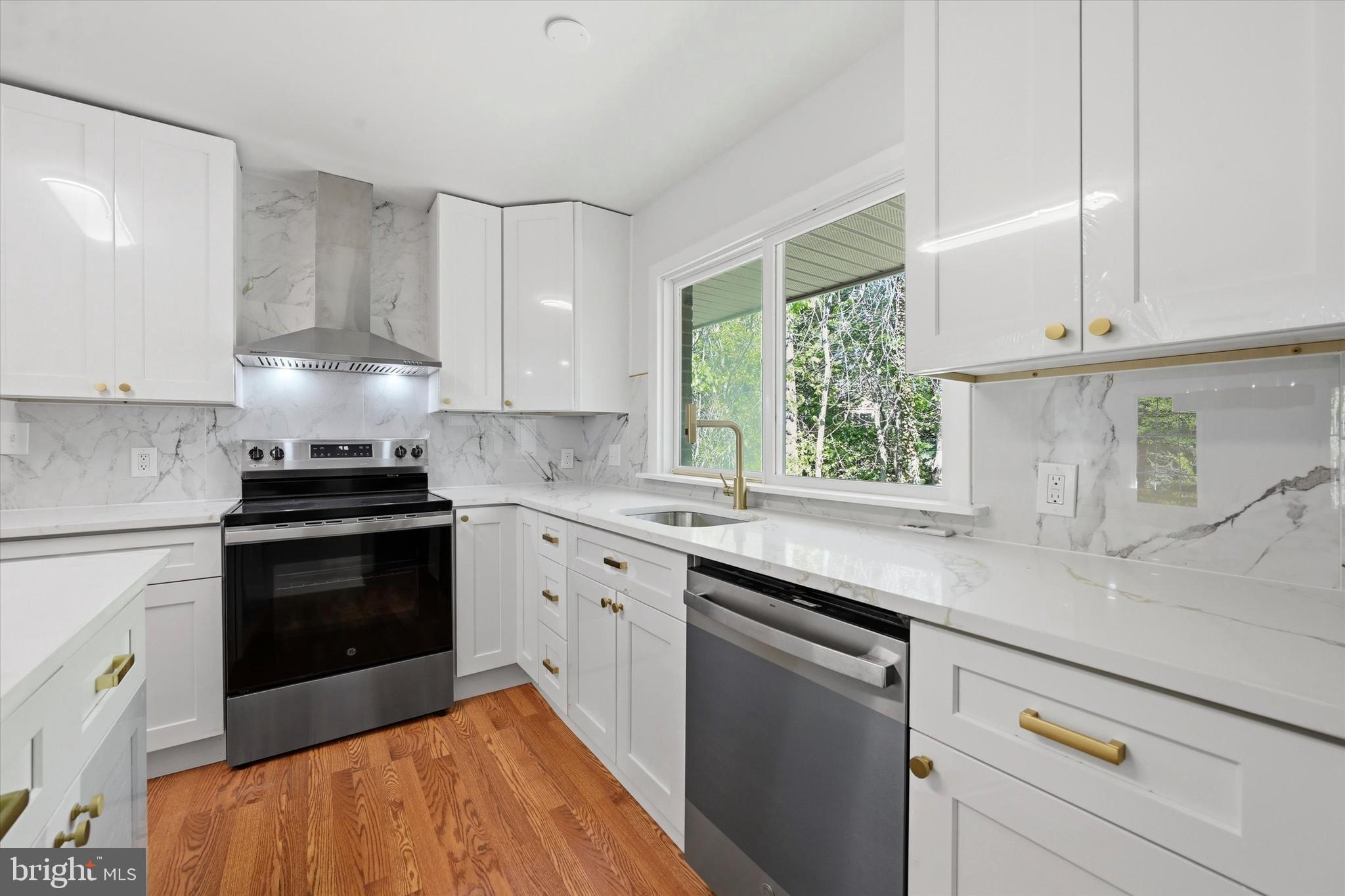103 Baynard Boulevard Wilmington, DE 19803 - Photo 12 of 35 a kitchen with granite countertop white cabinets and white appliances