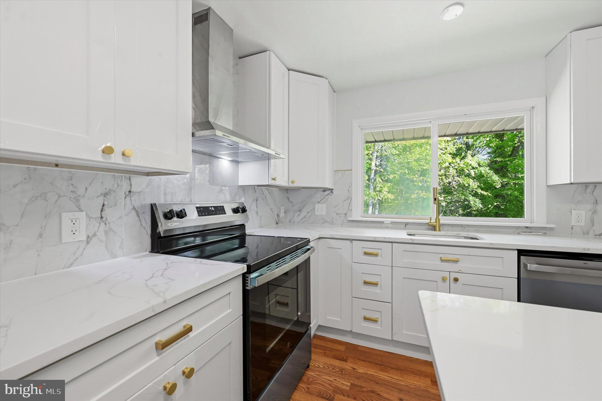 103 Baynard Boulevard Wilmington, DE 19803 - Photo 14 of 35 a kitchen with a stove a sink and a window